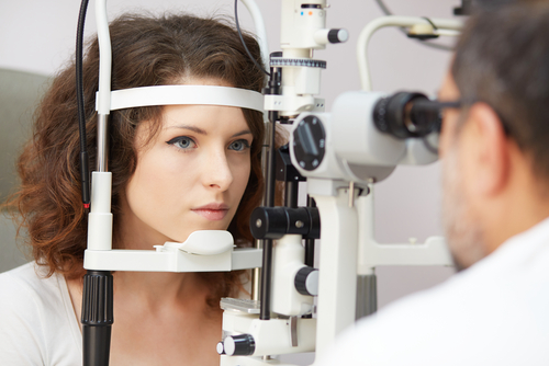 eye doctor performing eye exam on patient 